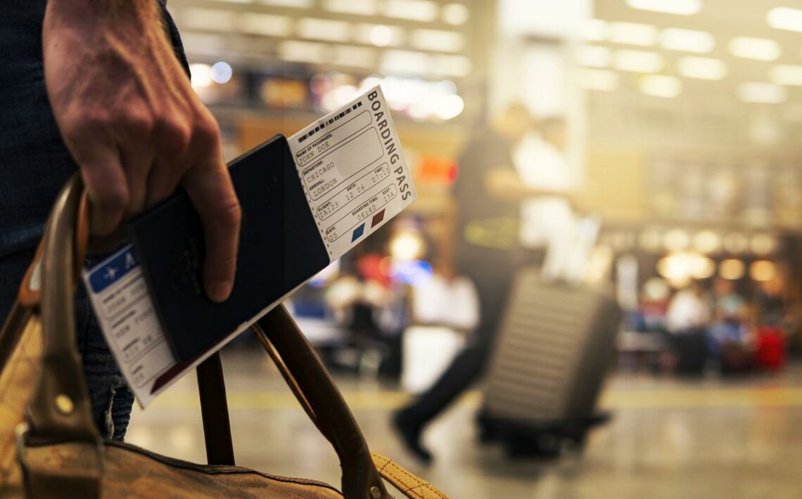 passport and plane ticket in hand